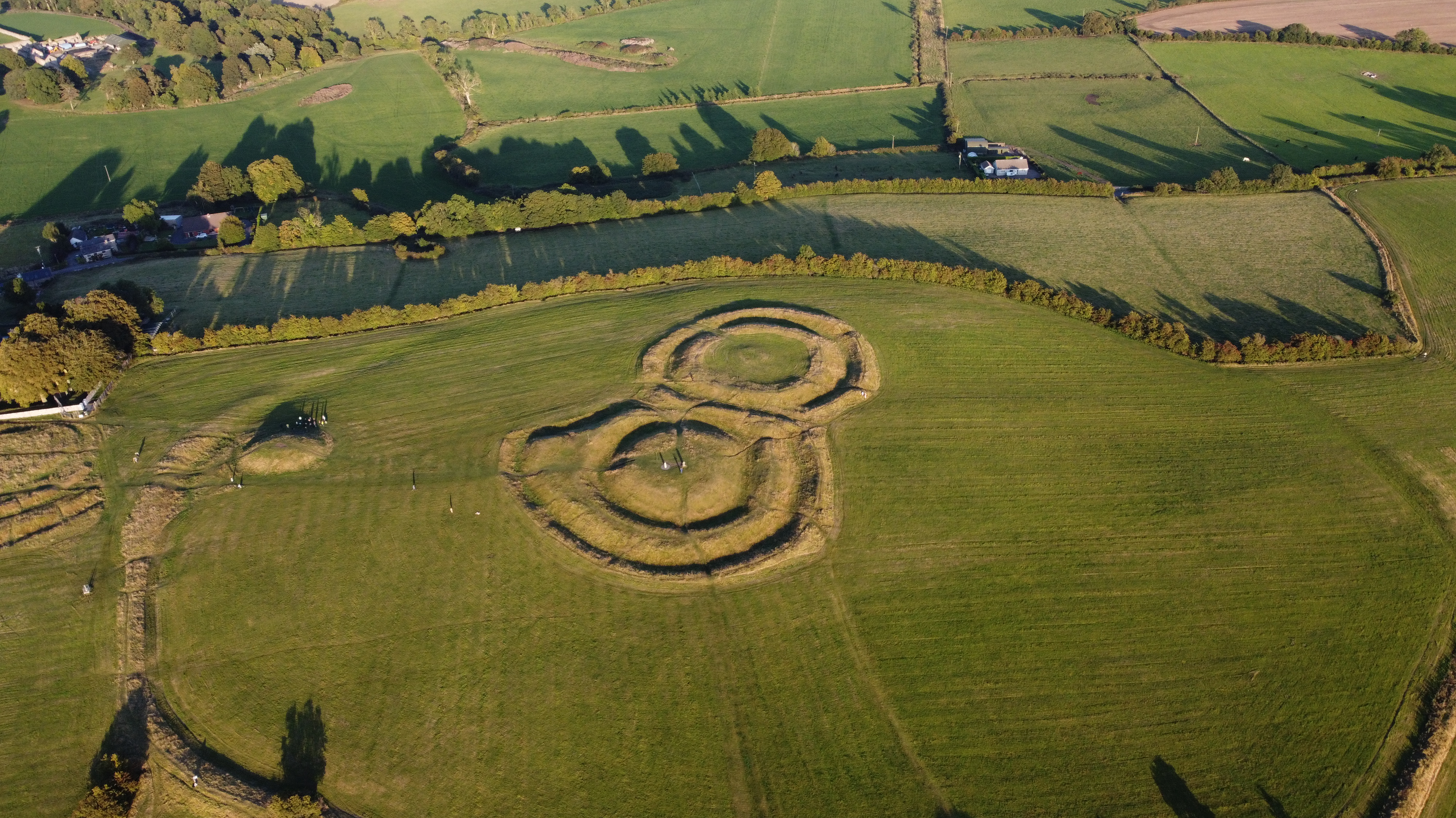 Wide aerial view of ancient ringfort earthworks in the Irish countryside, Co. Meath